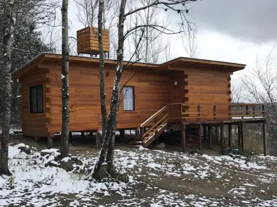 a log cabin in the woods in the snow at Cabañas San Urbano 1 in Villa Yacanto