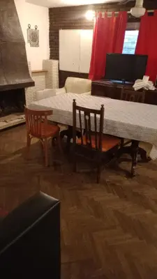 a living room with a table and chairs and a piano at Amplio 2 Dormitorios en Cofico in Cordoba