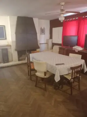 a dining room with a table and chairs and a fireplace at Amplio 2 Dormitorios en Cofico in Cordoba