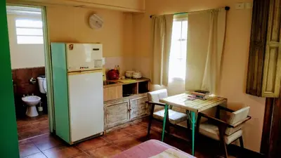 a kitchen with a white refrigerator and a table at apartamento VINTAGE LU in Merlo