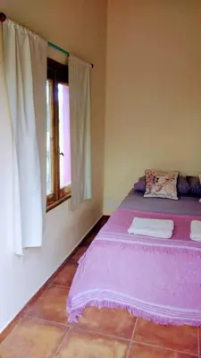 a bedroom with a purple bed and a window at apartamento VINTAGE LU in Merlo