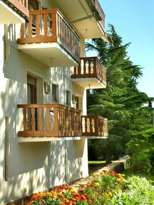 a building with wooden balconies on the side of it at Hotel Edelweiss in Villa General Belgrano