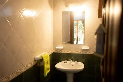 a bathroom with a sink and a mirror at Cabañas El Vallecito in Villa del Dique