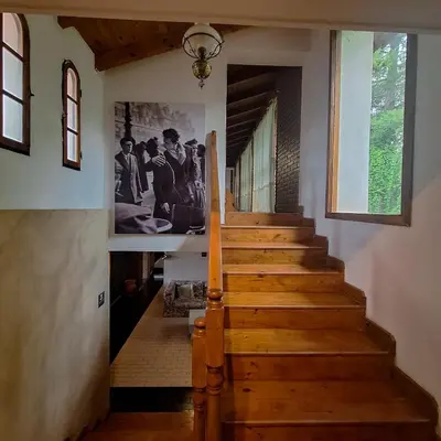 a staircase in a house with a picture on the wall at Hotel Antiguo Camino in Villa General Belgrano