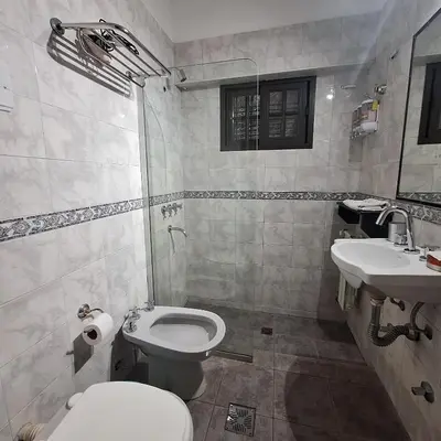 a bathroom with a toilet and a sink at Hotel Antiguo Camino in Villa General Belgrano
