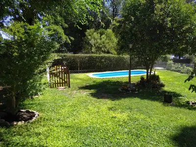 a yard with a swimming pool in the grass at Rincón Sereno in Villa General Belgrano