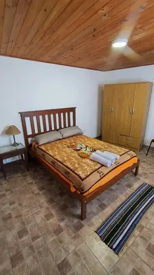 a large bed in a room with a wooden ceiling at Mirador Sierras in Alta Gracia