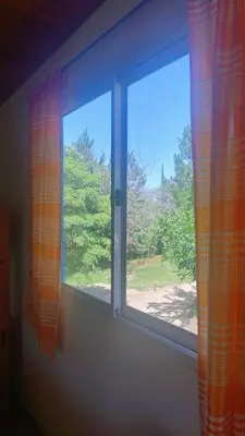 a window in a room with a view of a yard at Mirador Sierras in Alta Gracia