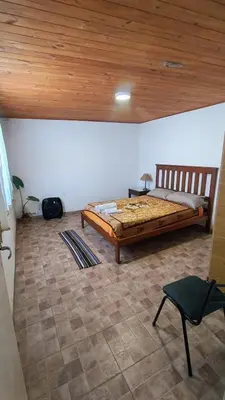a bedroom with a bed and a wooden ceiling at Mirador Sierras in Alta Gracia