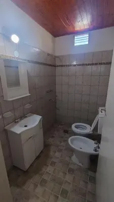 a bathroom with a toilet and a sink at Mirador Sierras in Alta Gracia