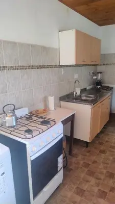 a kitchen with a stove and a counter top at Mirador Sierras in Alta Gracia
