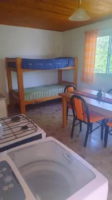 a living room with a bed and a table and chairs at Mirador Sierras in Alta Gracia