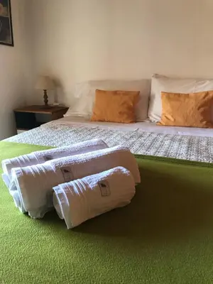 a bedroom with two beds with towels on them at DEPTO EN VILLA GRAL BELGRANO in Villa General Belgrano