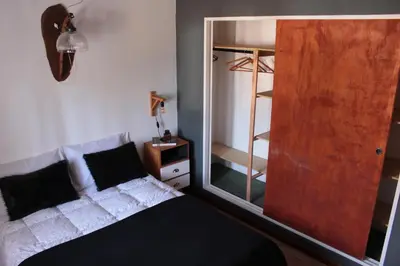 a bedroom with a bed and a large mirror at DEPTO EN VILLA GRAL BELGRANO in Villa General Belgrano