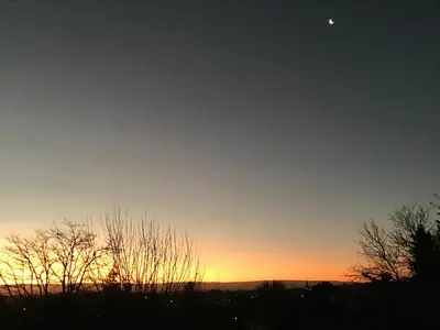 a sunset with the moon in the sky at DEPTO EN VILLA GRAL BELGRANO in Villa General Belgrano