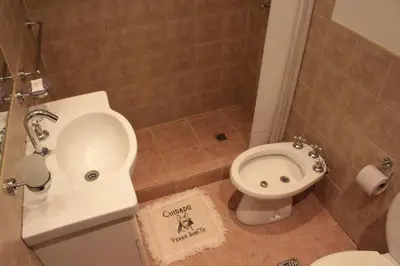 a bathroom with a toilet and a sink at DEPTO EN VILLA GRAL BELGRANO in Villa General Belgrano