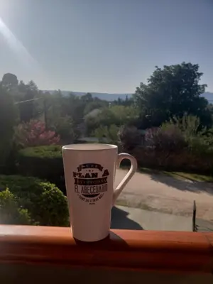 a coffee cup sitting on a window sill at Cabañas Las Pencas in Mina Clavero