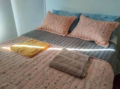 a bed with two pillows and a blanket on it at Las Tejas in Cordoba