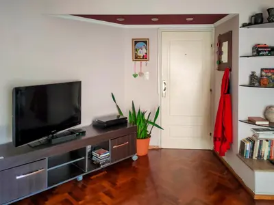 a living room with a flat screen tv on a entertainment center at Las Tejas in Cordoba