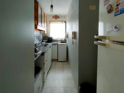 a small kitchen with white appliances and a window at Las Tejas in Cordoba