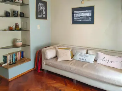a couch with pillows on it in a living room at Las Tejas in Cordoba