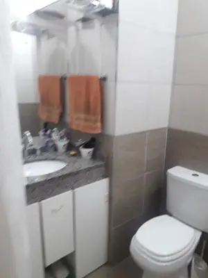 a bathroom with a toilet and a sink at Departamento Entre Rios in Villa Carlos Paz