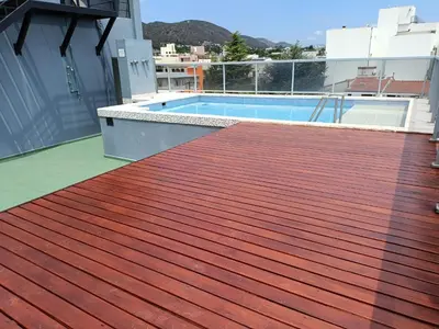 a deck with a swimming pool on top of a building at Departamento Entre Rios in Villa Carlos Paz