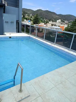 a large swimming pool on top of a building at Departamento Entre Rios in Villa Carlos Paz