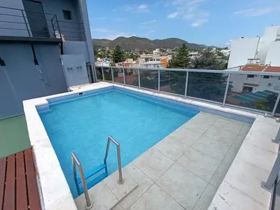 a swimming pool on the roof of a building at Departamento Entre Rios in Villa Carlos Paz