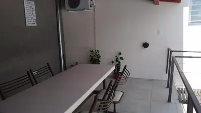 a room with a white counter with chairs and a table at PINZON 1984 in Cordoba