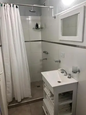 a bathroom with a white shower curtain and a sink at PINZON 1984 in Cordoba