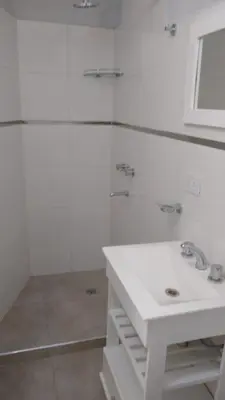 a white bathroom with a sink and a shower at PINZON 1984 in Cordoba