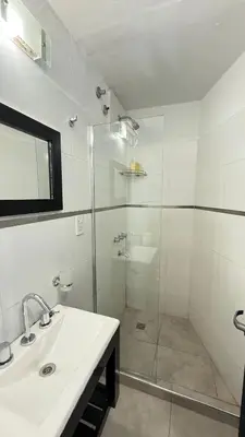 a bathroom with a glass shower and a sink at PINZON 1984 in Cordoba