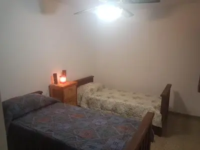 a bedroom with two beds and a night stand with a lamp at Departamento a estrenar excelente ubicacion, 1 cuadra de la terminal in Cordoba