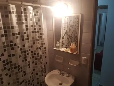 a bathroom with a sink and a mirror at Departamento a estrenar excelente ubicacion, 1 cuadra de la terminal in Cordoba