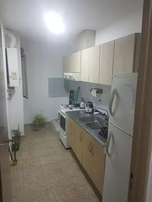 a kitchen with a white refrigerator and a sink at Departamento a estrenar excelente ubicacion, 1 cuadra de la terminal in Cordoba