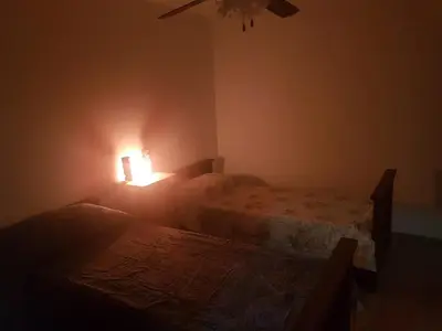 a bedroom with two beds and a light on the wall at Departamento a estrenar excelente ubicacion, 1 cuadra de la terminal in Cordoba