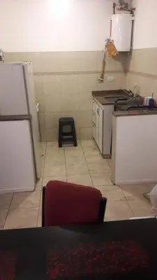 a kitchen with a white refrigerator and a stove at DPTO ALTA CORDOBA in Cordoba