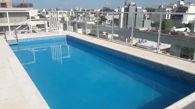 a large blue swimming pool on top of a building at DPTO ALTA CORDOBA in Cordoba