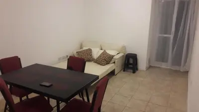 a living room with a table and a white couch at DPTO ALTA CORDOBA in Cordoba