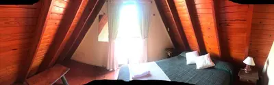 a bedroom with a bed and a window at Cabañas Ayres del cerro in Merlo