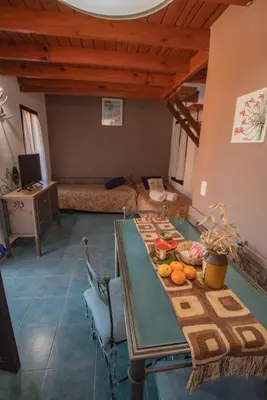 a room with a table with fruit on it at Cabañas Dalga Inn in Merlo