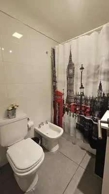 a bathroom with a toilet and a shower curtain with big ben at LitStay Laprida in Cordoba