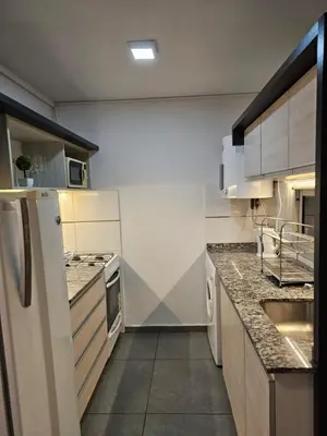 a kitchen with white appliances and granite counter tops at LitStay Laprida in Cordoba