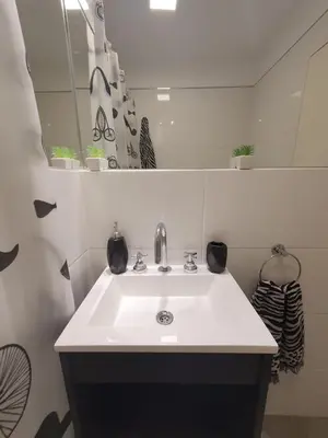 a bathroom with a white sink and a mirror at LitStay Laprida in Cordoba