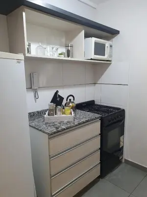 a small kitchen with a stove and a microwave at LitStay Laprida in Cordoba