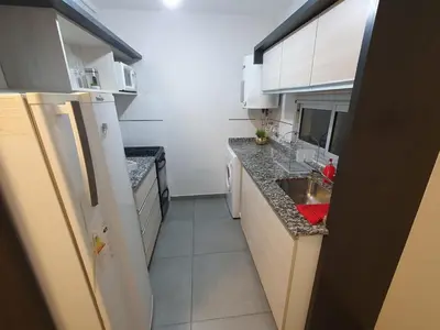 a small kitchen with white appliances and a sink at LitStay Laprida in Cordoba