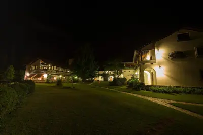 a group of houses at night with lights at Bremen Hotel & Spa in Villa General Belgrano