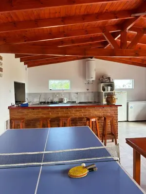 a blue ping pong table in a kitchen at Cabañas PAIGÜEN in Villa Yacanto