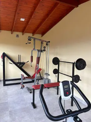 a gym with several exercise equipment in a room at Cabañas PAIGÜEN in Villa Yacanto